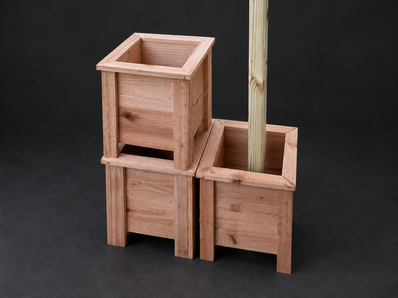 Three unfinished cedar covers and planters grouped around a timber, with a retouched dark background
