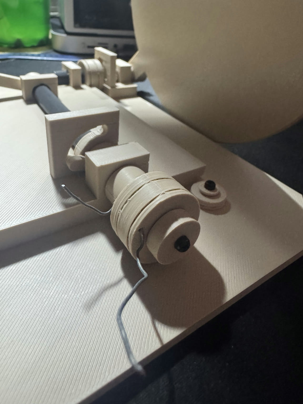 Cream-colored printed cord drums and supports in the partially assembled Easter Tomb model